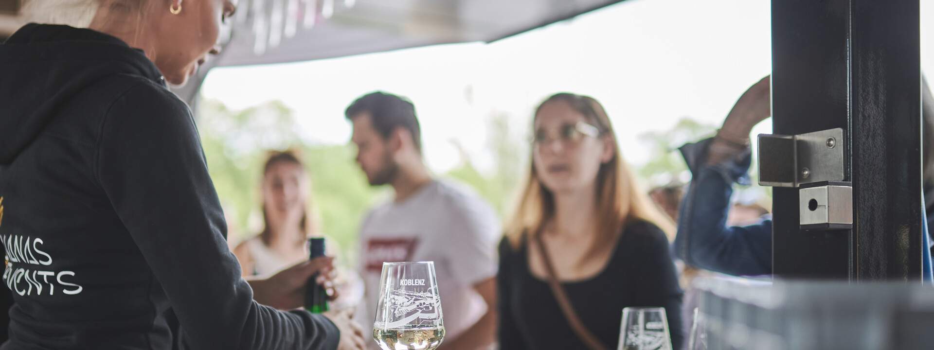 Ein Glas Wein steht auf der Weintheke und Kunden bestellen © Koblenz-Touristik GmbH, Picture Colada Ein Glas Wein steht auf der Weintheke und Kunden bestellen © Koblenz-Touristik GmbH, Picture Colada